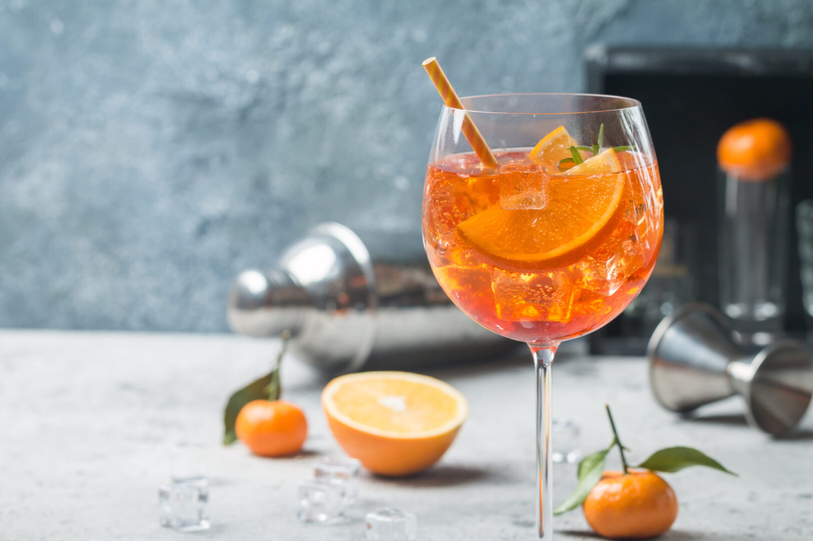 Classic Italian Aperol spritz cocktail in glass on gray background