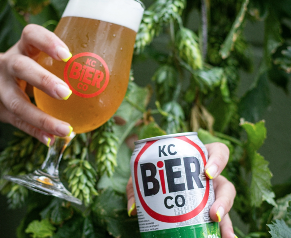 KCBierCo_Beer_Can Hands holding a beer glass and beer can from KC Bier Company.